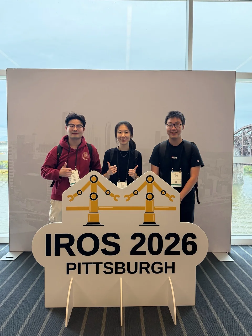 Chuchu Chen and two EPIC Lab students at IROS 2026 in Pittsburgh.